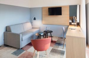 a living room with a couch and a table at Hotel Schwanen in Köngen