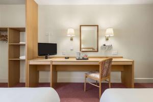 a hotel room with a bed, desk and chair at Days Inn Chesterfield - Tibshelf in Tibshelf