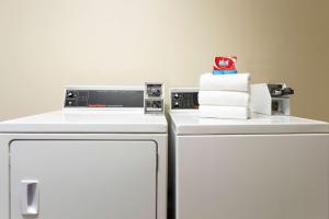 a white refrigerator with a stack of towels on top of it at Days Inn by Wyndham Beaver in Beaver