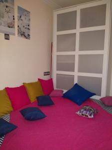 a room with a large bed with colorful pillows at Cosy apartment Acropolis Point-3 in Athens
