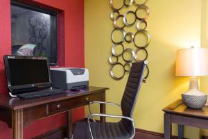 a desk with a computer and a printer on it at Days Inn by Wyndham High Point/Archdale in Archdale