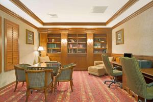a library with chairs and a table and a couch at Days Inn by Wyndham St. Louis/Westport MO in Maryland Heights