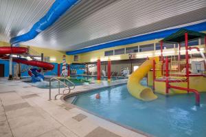 a large indoor water park with a slide and a water slide at Days Inn by Wyndham Fargo/Casselton in Casselton