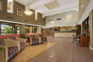 a lobby of a hospital with couches and a kitchen at Days Inn by Wyndham Buena Park in Buena Park