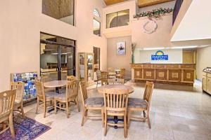 a dining room with tables and chairs in a restaurant at Days Inn & Suites by Wyndham Red Rock-Gallup in Gallup