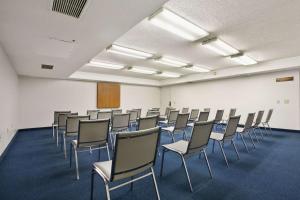 a room with rows of chairs in a classroom at Days Inn by Wyndham Buena Park in Buena Park +35 photos