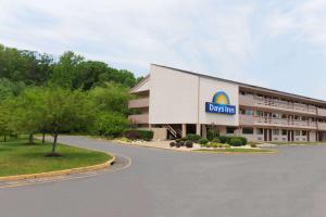a building with a sign on the side of it at Days Inn by Wyndham Monmouth Junction-S Brunswick-Princeton in Monmouth Junction
