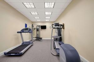 a gym with treadmills and machines in a room at Days Inn by Wyndham Victoria in Victoria