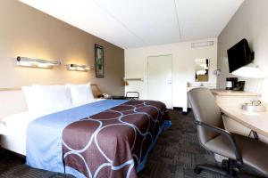 a hotel room with a bed and a desk at Days Inn by Wyndham Monmouth Junction-S Brunswick-Princeton in Monmouth Junction