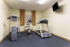 a gym with two exercise bikes and a flat screen tv at Days Inn by Wyndham Colorado Springs Airport in Colorado Springs
