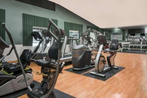 a gym with several treadmills and elliptical machines at Days Inn by Wyndham Fargo/Casselton in Casselton
