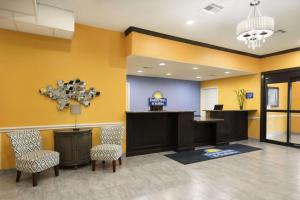 a lobby of a hospital with chairs and a counter at Days Inn & Suites by Wyndham Galveston West/Seawall in Galveston +22 photos