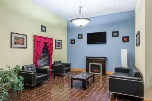 a waiting room with chairs and a fireplace at Days Inn & Suites by Wyndham Casey in Casey
