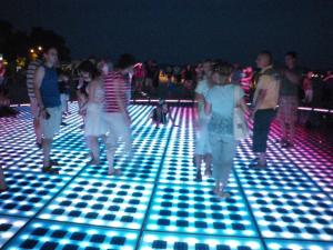 a group of people walking on a dance floor with lights at Casa Del Sol Bed&Breakfast in Sukošan