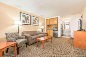 a living room with a couch and a chair and a table at Days Inn by Wyndham Altus in Altus