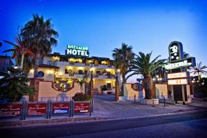 a hotel with palm trees in front of it at Hotel Smeraldo in Qualiano