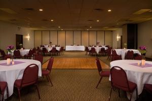 a banquet hall with tables and chairs and white tablecloths at Days Inn by Wyndham Altus in Altus