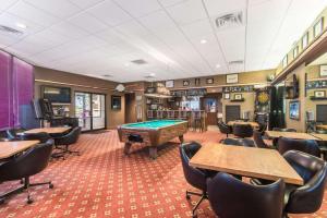 a billiard room with a pool table and chairs at Days Inn by Wyndham Altus in Altus
