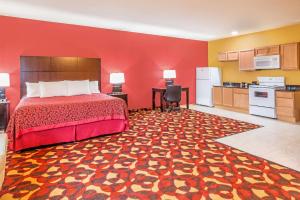 um quarto de hotel com uma cama e uma cozinha em Days Inn & Suites by Wyndham El Dorado em El Dorado