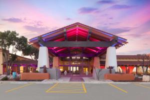 a large building with a pink in a parking lot at Days Inn by Wyndham Uvalde in Uvalde