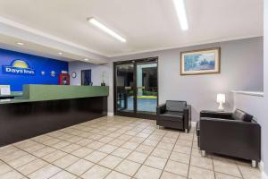 a waiting room with a desk and two chairs at Days Inn by Wyndham Lugoff in Lugoff