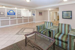 a lobby with two chairs and a waiting room at Days Inn & Suites by Wyndham Arlington Heights in Arlington Heights
