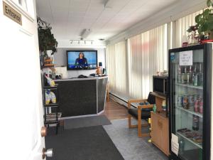 an office with a desk with a tv in a room at Hilltop Motel in Kingston