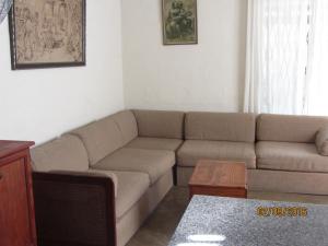 a living room with a couch and a table at Toad Tree Cabins in Sodwana Bay