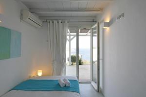 Un dormitorio con una cama con dos toallas blancas encima. en Plan-B Holidays, en Playa Kalo Livadi
