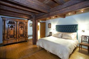 a bedroom with a large bed and a wooden ceiling at Hôtel & Spa Le Bouclier D'or in Strasbourg +53 photos