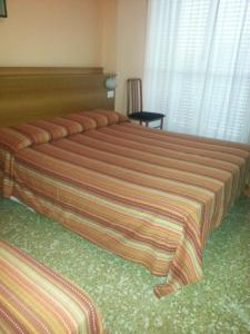 Postel nebo postele na pokoji v ubytování Hotel Lombardia