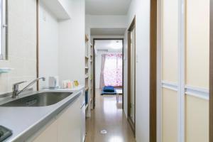 a kitchen with a sink and a mirror at A&B Omoromachi Station in Naha +52 photos