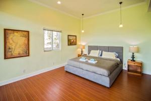 a bedroom with a bed and a wooden floor at Casa Ejecutiva Boquete in Boquete