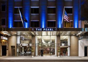 a man standing in front of the pearl building at The Pearl Hotel in New York