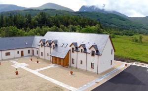 an aerial view of a barn with mountains in the background at Tower Ridge Courtyard in Fort William
