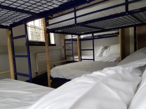 
two bunk beds in a small room at Rock n Bowl in Bristol
