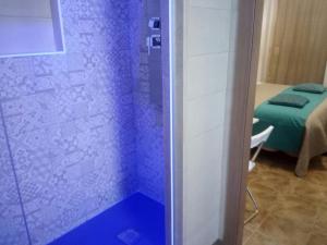 a shower in a room with a blue shower at Le Suite dei Due Mari cucinino privato in Taranto