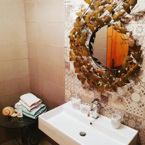 a bathroom with a sink and a mirror at Sunshine Court in St Paul's Bay