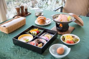 a green table with a tray of food on it at Hotel Sainthill Nagasaki in Nagasaki