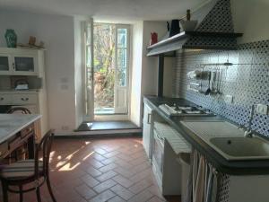 a kitchen with a sink and a stove and a window at Country House in Portofino Mount & Natural Park in Portofino