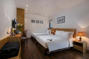 Postel nebo postele na pokoji v ubytování Hanoi Paon Hotel & Spa