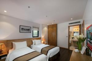 Postel nebo postele na pokoji v ubytování Hanoi Paon Hotel & Spa