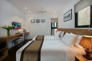 Postel nebo postele na pokoji v ubytování Hanoi Paon Hotel & Spa