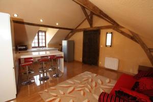 a kitchen with a counter and stools in a room at Château de Belle Poule in Les Ponts-de-Cé