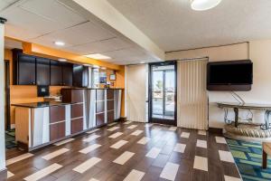 a large room with a kitchen and a tv at Motel 6-Kenly, NC in Kenly