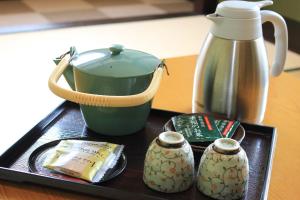 a tray with a teapot and a coffee maker at Daisen View Heights in Daisen