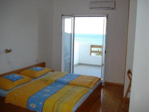 a bedroom with two beds and a view of the ocean at House Zaca in Zavala