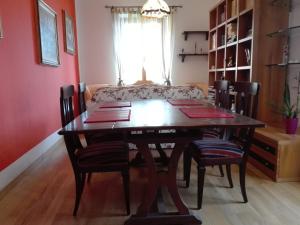 a dining room table with chairs and a couch at La Torretta bed & breakfast in Torriglia