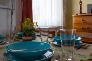 a table with blue bowls and plates and glasses at Apartment near the Heroes Square in Budapest