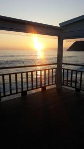 a view of the ocean at sunset from a porch at Casa Burrasca in Levanto